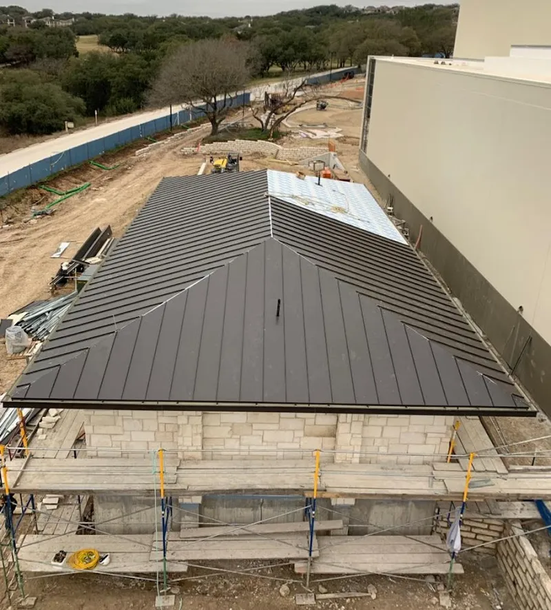 Metal roof new construction with scaffolding in Springdale