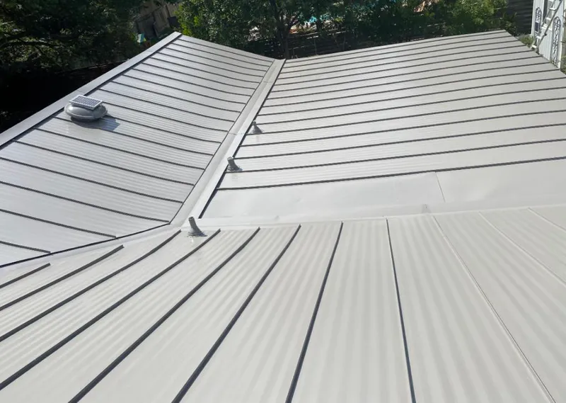 Solar attic fan installed on a metal roof for Roof Ventilation in Springdale